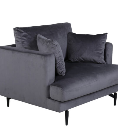 Fauteuil de salon gris Soren en velours avec assise profonde et pieds acier noir dans un intérieur contemporain