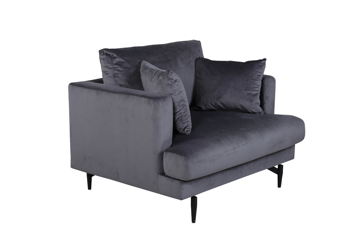 Fauteuil de salon gris Soren en velours avec assise profonde et pieds acier noir dans un intérieur contemporain